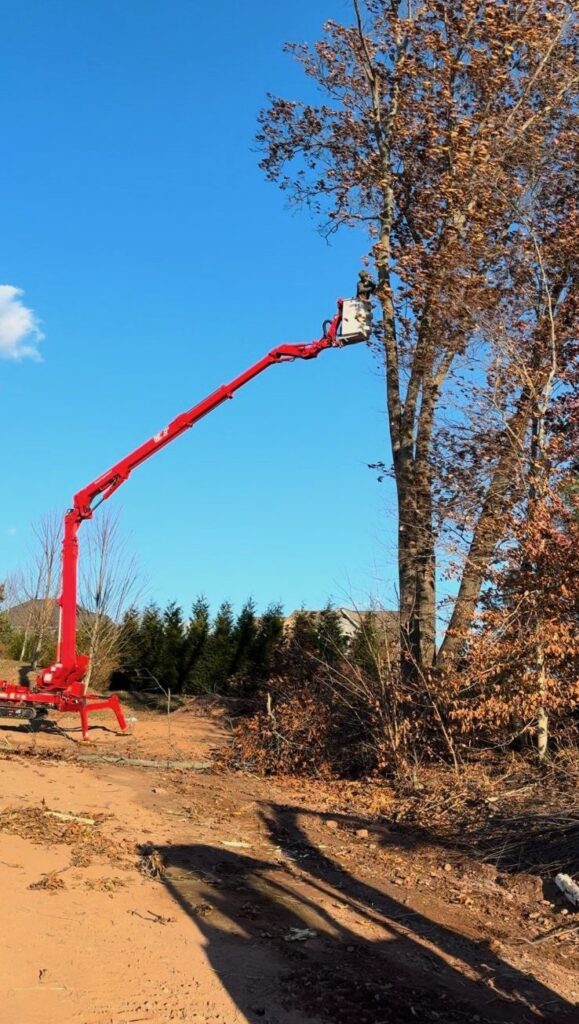 Bill's Landscaping 92-foot CMC backyard specialty lift extended for tree removal